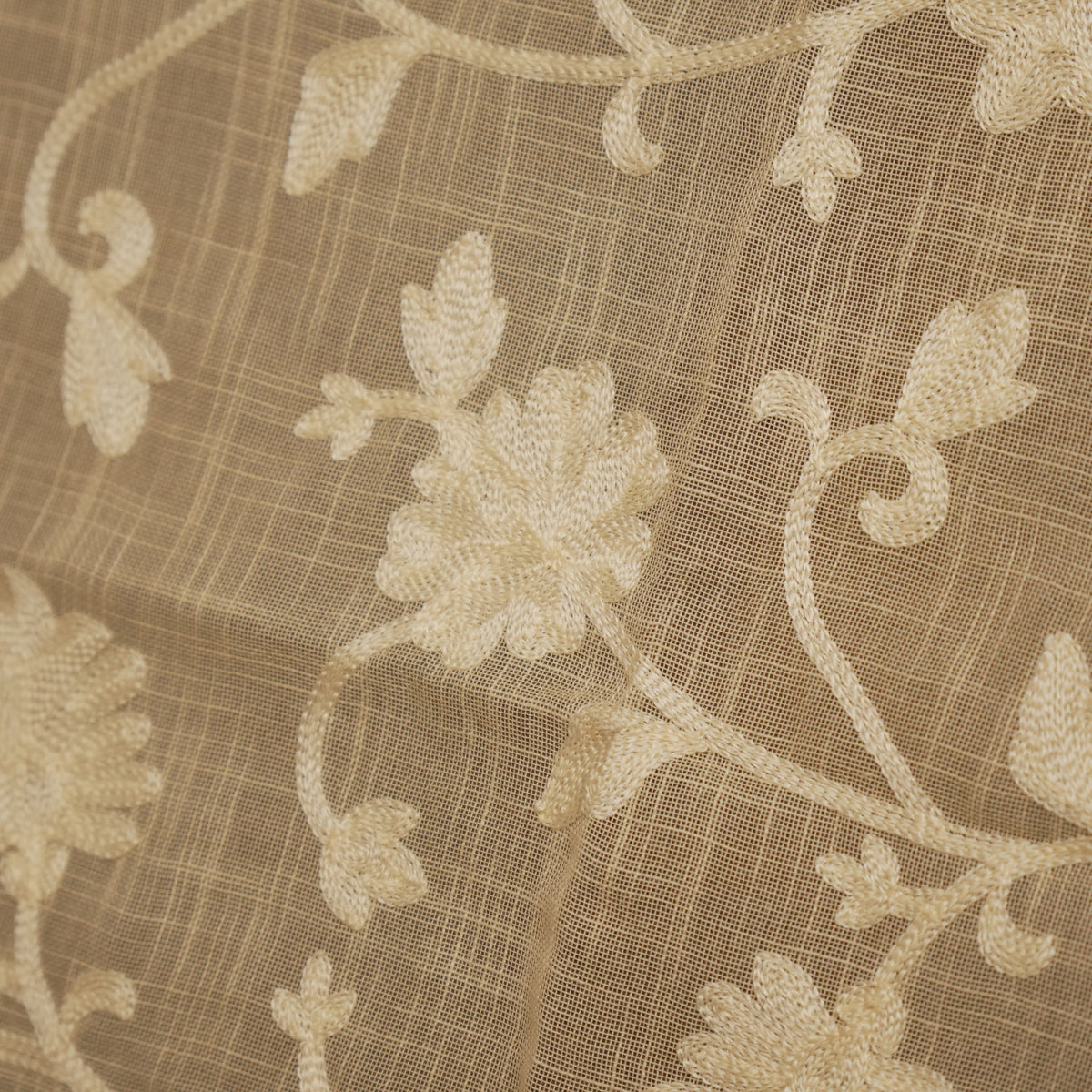 Close-up of the cream floral embroidery