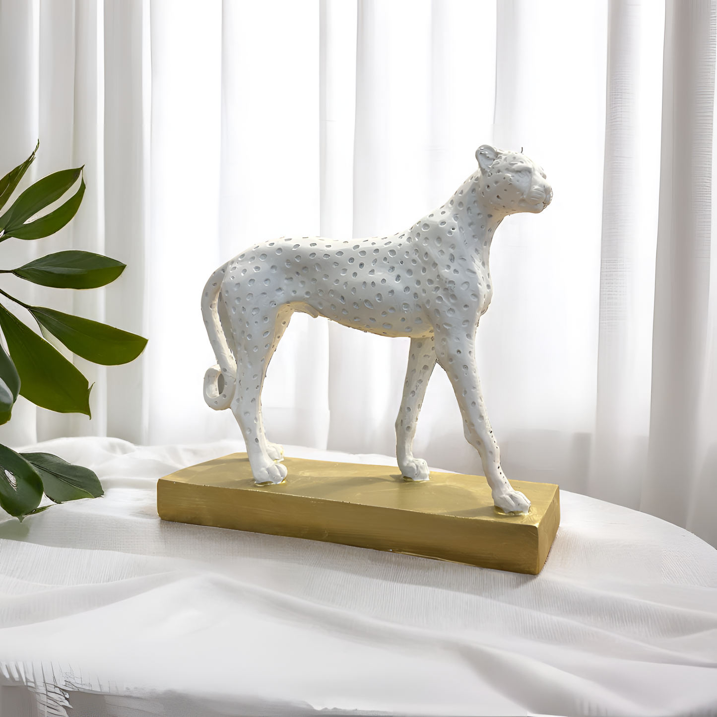White Cheetah Sculpture on Golden Base