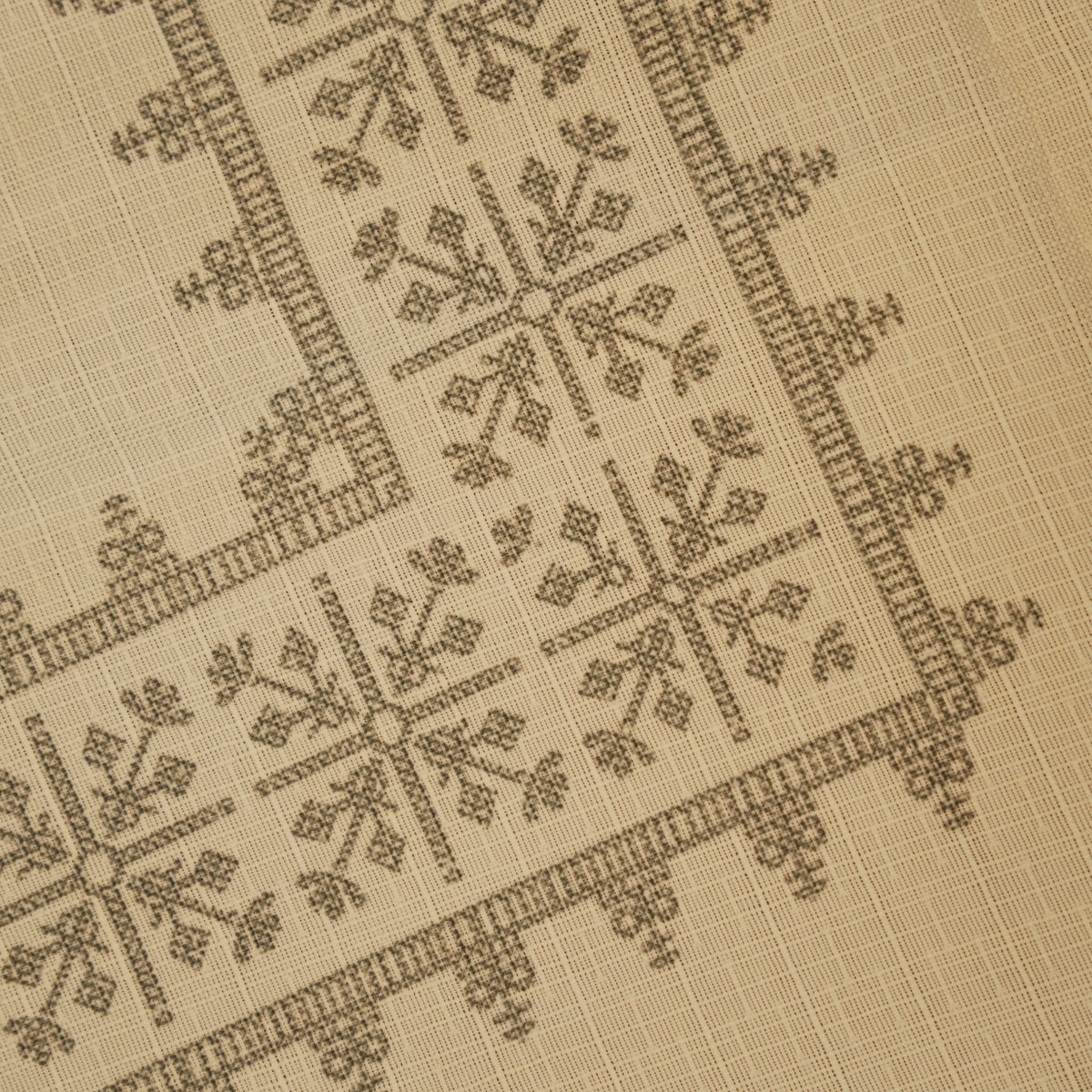 Close-up of the grey cross-stitch geometric pattern