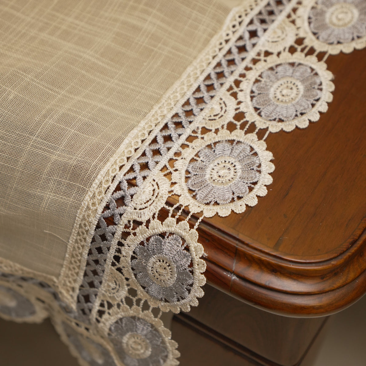 Grey medallion lace border at the table edge