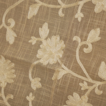 Close-up of the cream floral embroidery