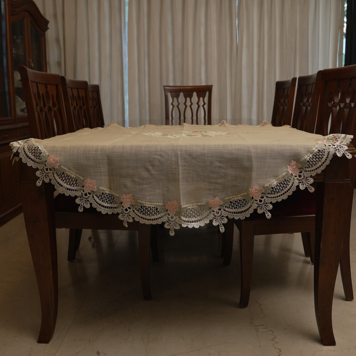 Pink rose lace round table sheet on a dining table
