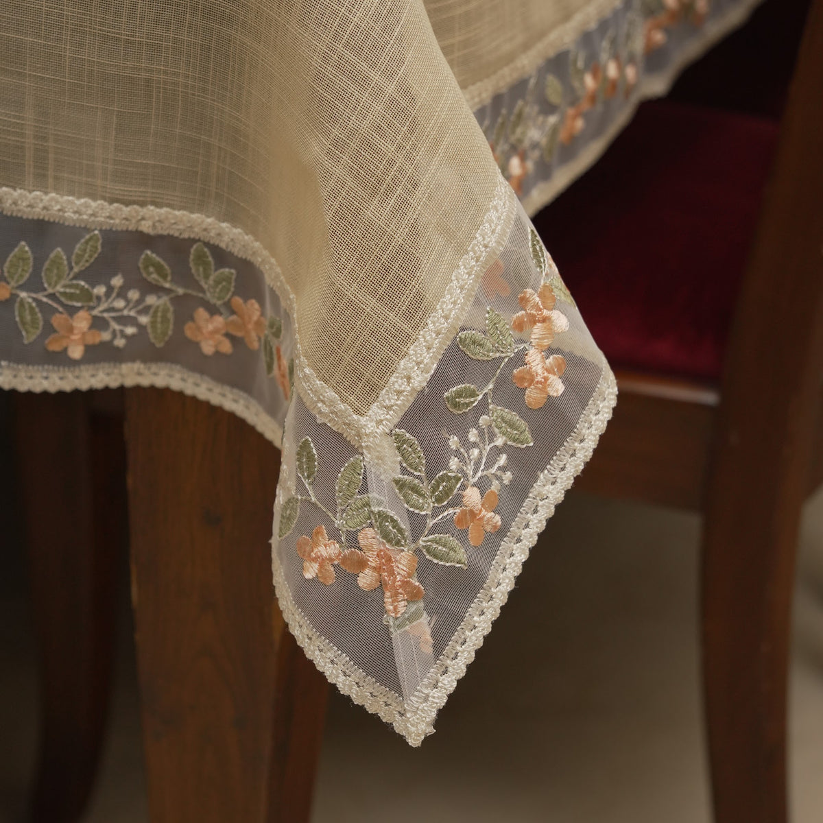 Corner drape showing the sheer embroidered peach floral border