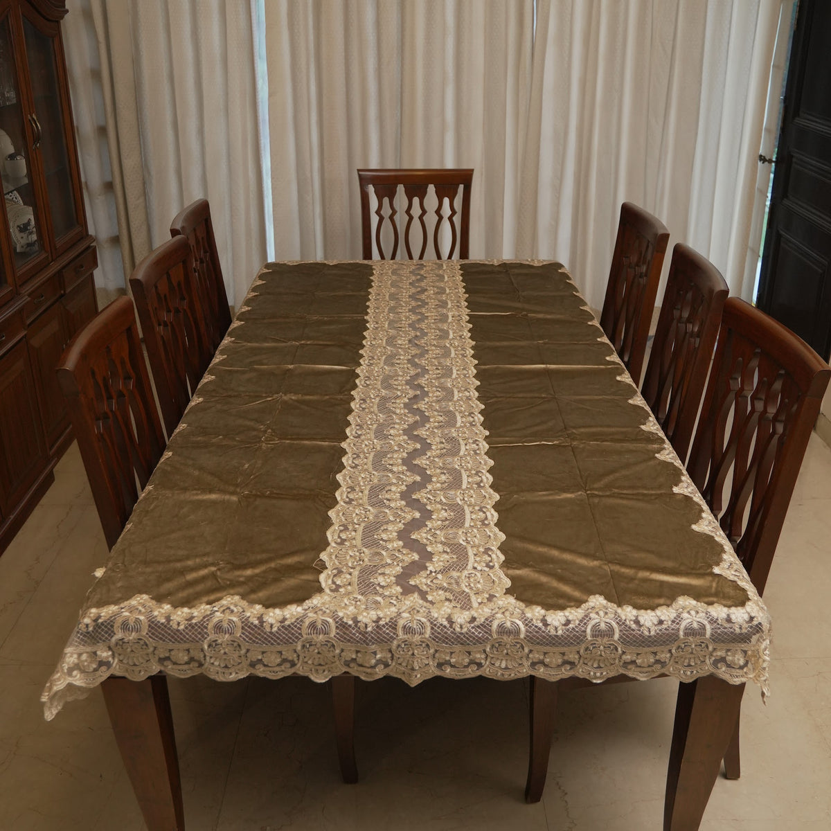 Olive gold table sheet with lace runner panel on an 8 seater dining table