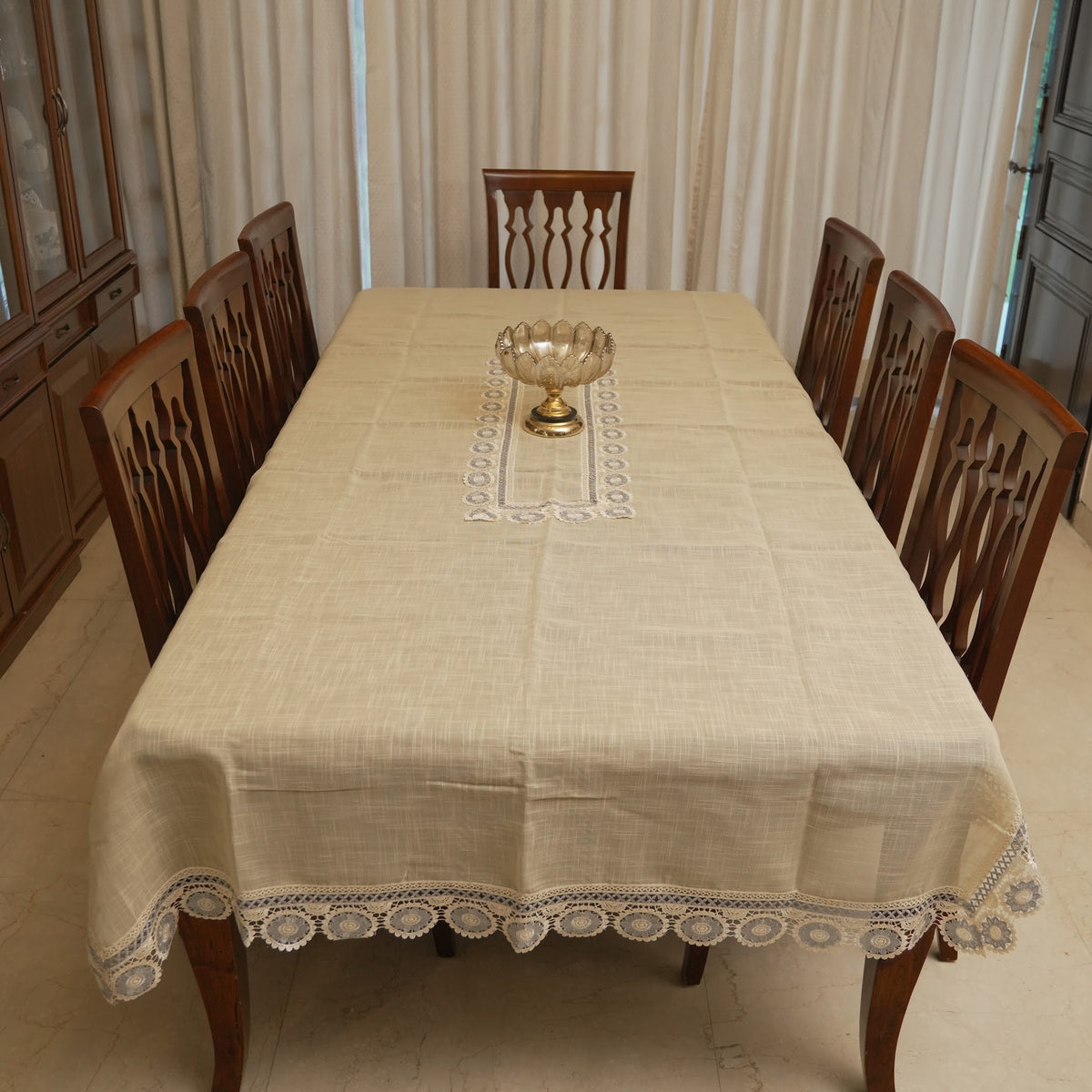 Grey medallion lace table sheet on a 10 seater dining table