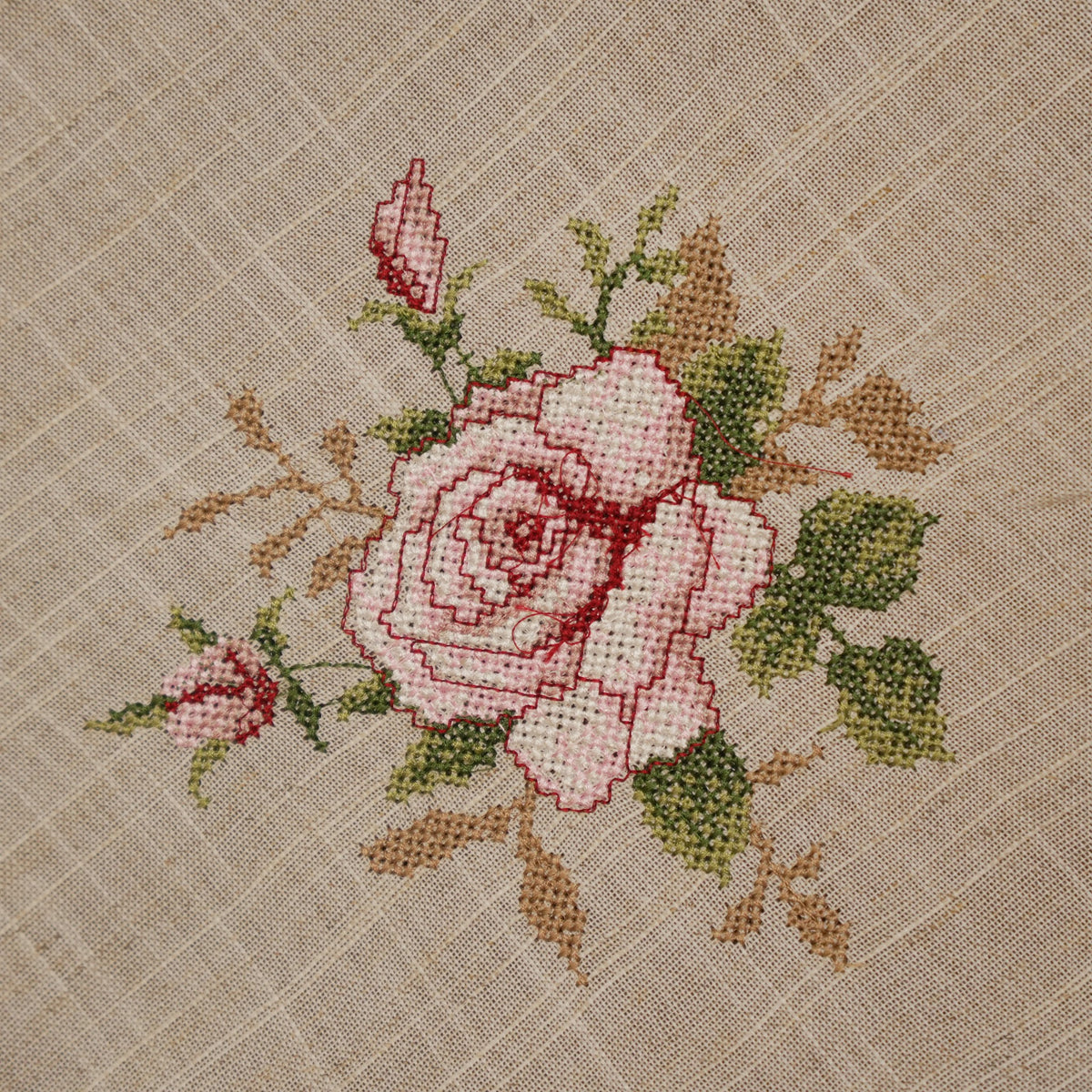Close-up of the pink cross-stitch rose