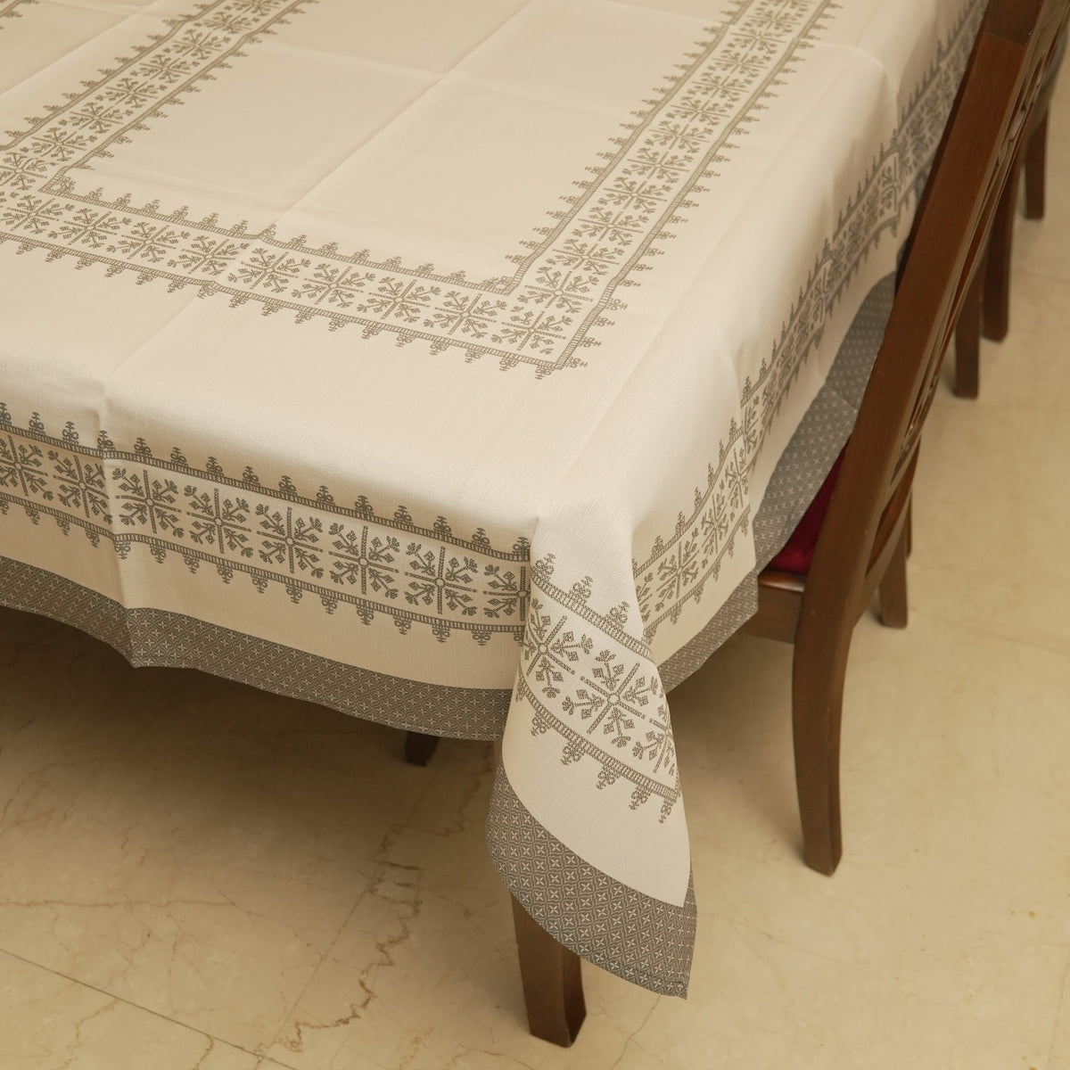 Corner of the table sheet with grey cross-stitch border