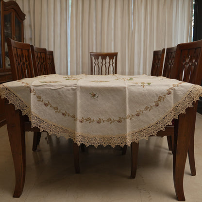 Cream cross-stitch rose round table sheet on a dining table