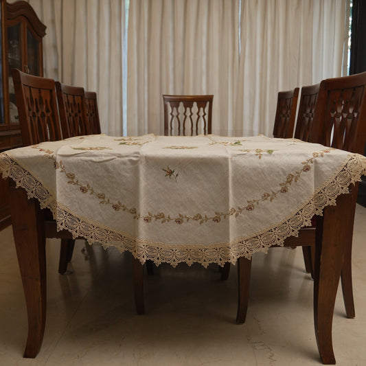 Cream cross-stitch rose round table sheet on a dining table