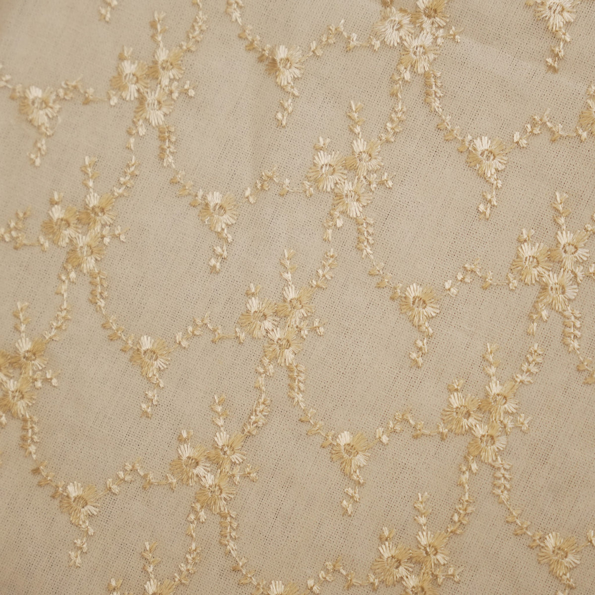 Close-up of the gold floral vine embroidery