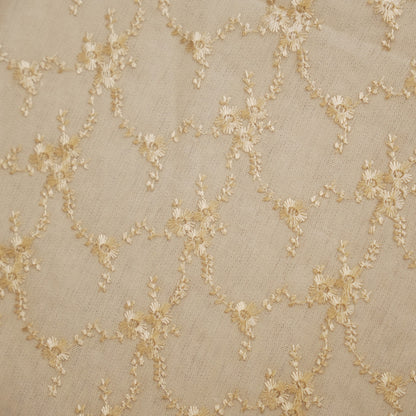 Close-up of the gold floral vine embroidery