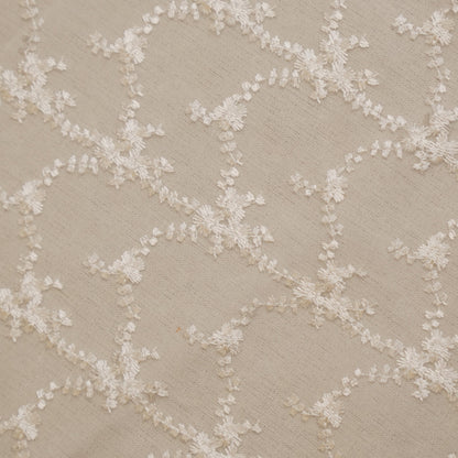 Close-up of the white floral vine embroidery