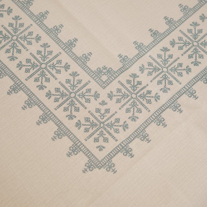 Close-up of the teal blue cross-stitch pattern