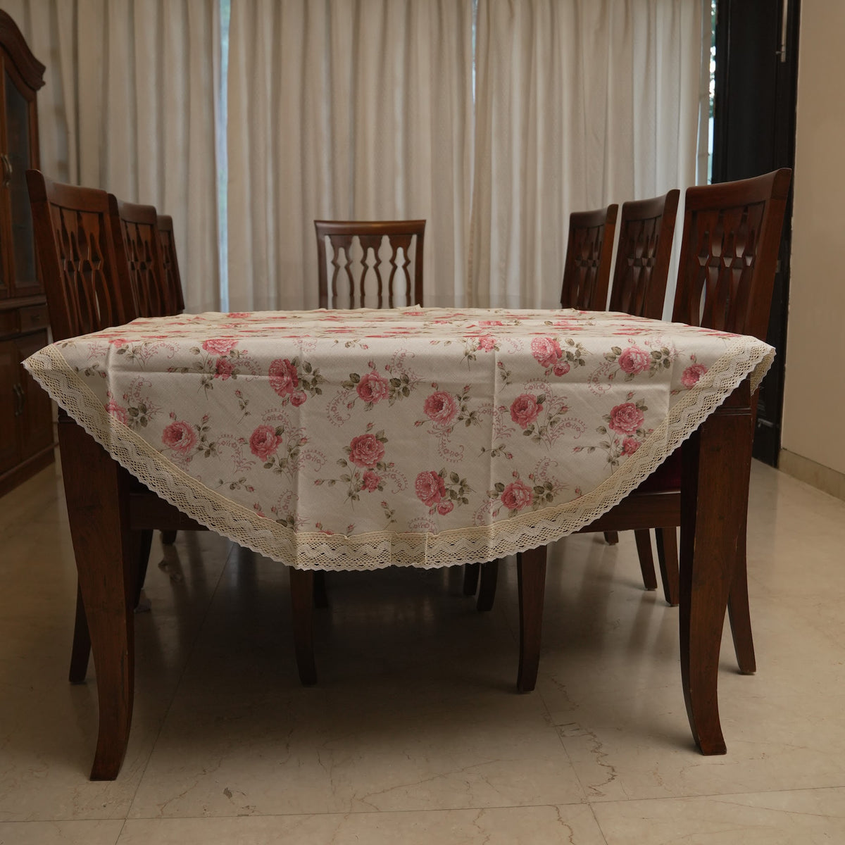 Pink rose print round table sheet on a dining table
