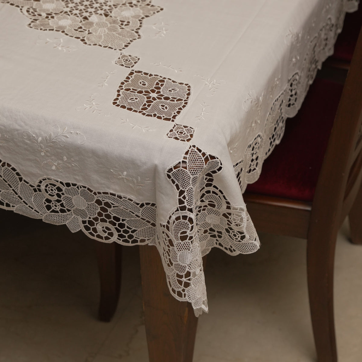 White cutwork lace table sheet on a 6 seater dining table
