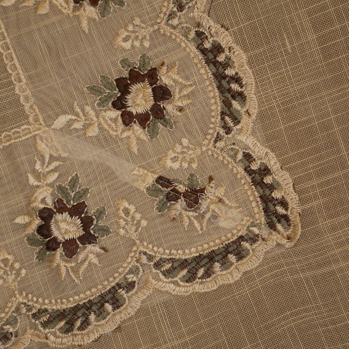 Close-up of the maroon and brown embroidered blossoms