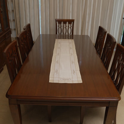 Cross-stitch floral linen runner on a dining table