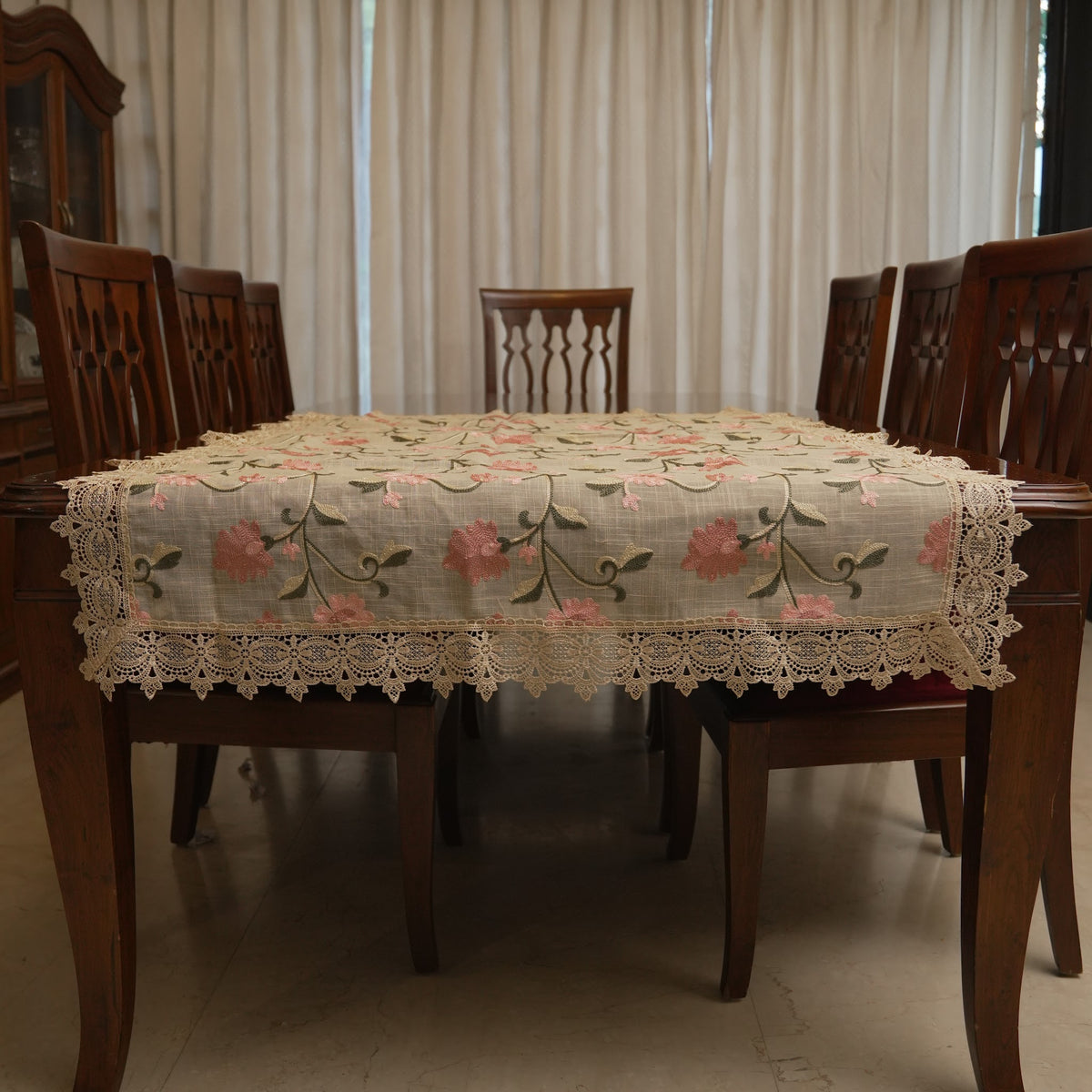 Pink floral embroidered table sheet on a dining table