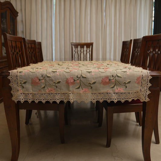 Pink floral embroidered table sheet on a dining table