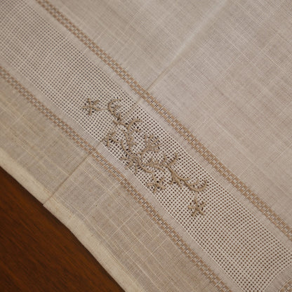 Close-up of the cross-stitch floral sprig