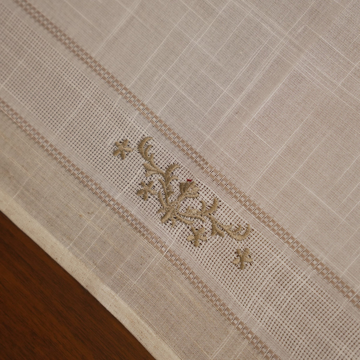 Close-up of the olive cross-stitch sprig