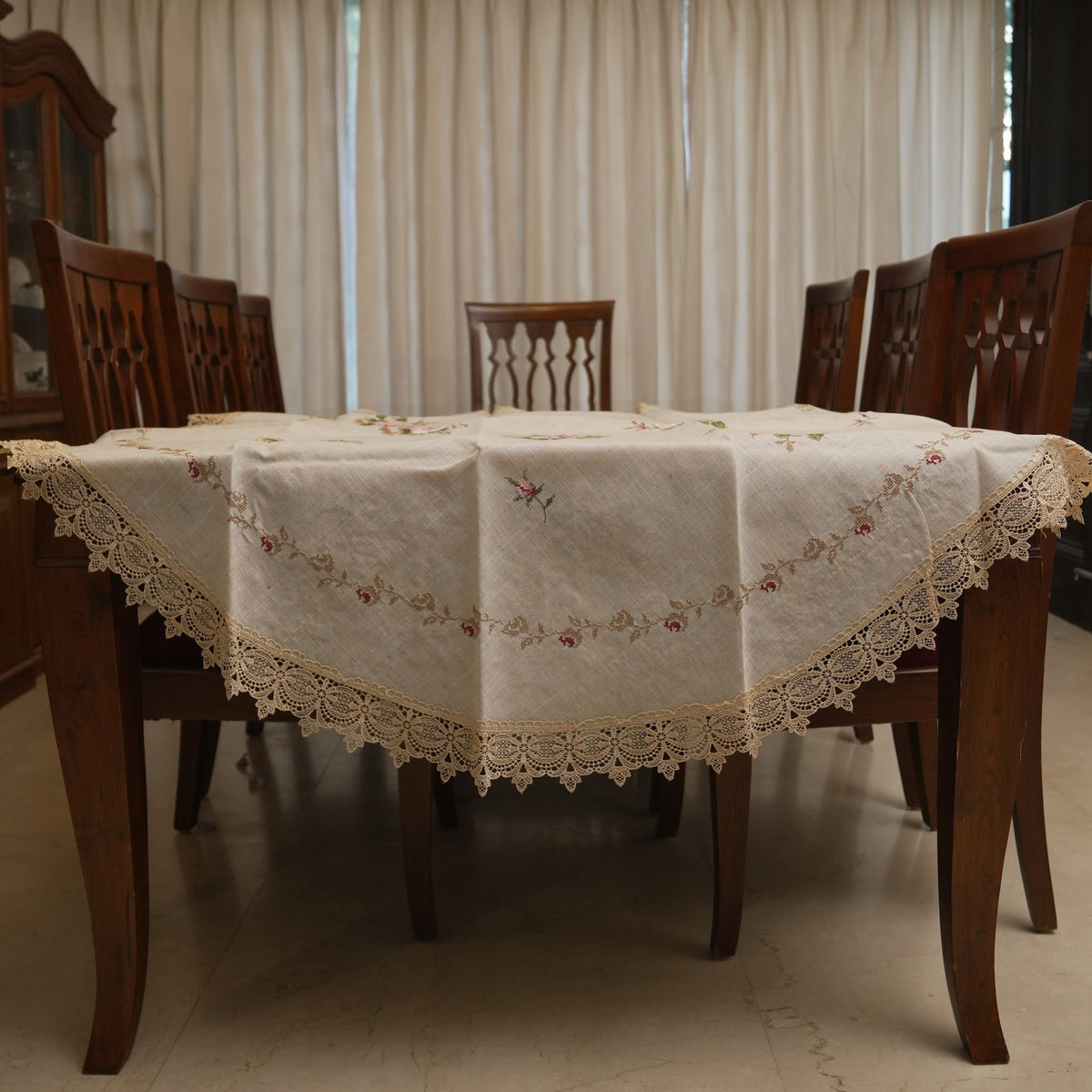 Pink cross-stitch rose round table sheet on a dining table