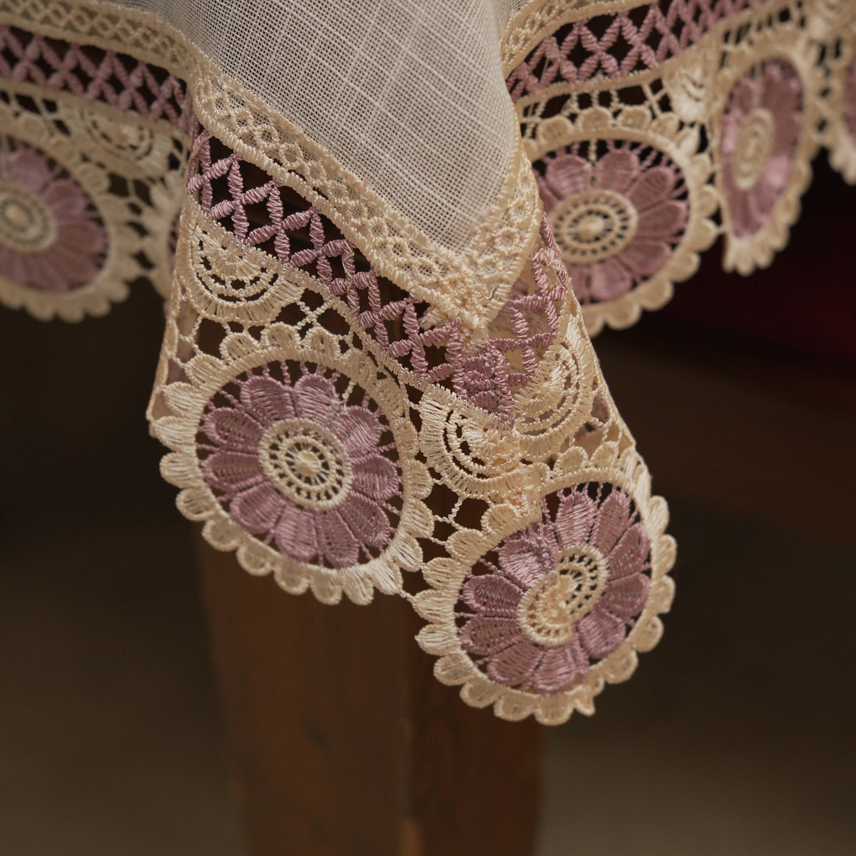 Corner drape showing the mauve crochet medallion lace border