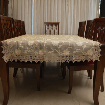 Cream floral embroidered table sheet on a dining table