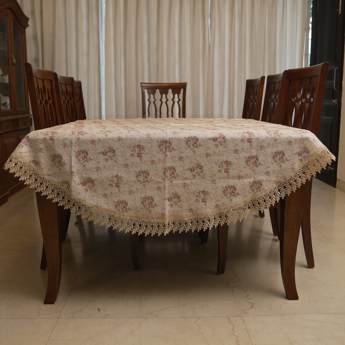 Blush rose print round table sheet on a dining table