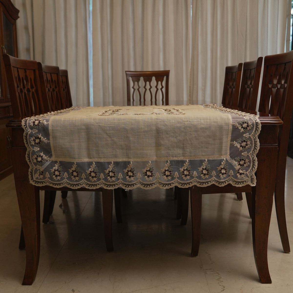 Maroon floral sheer border table sheet on a dining table